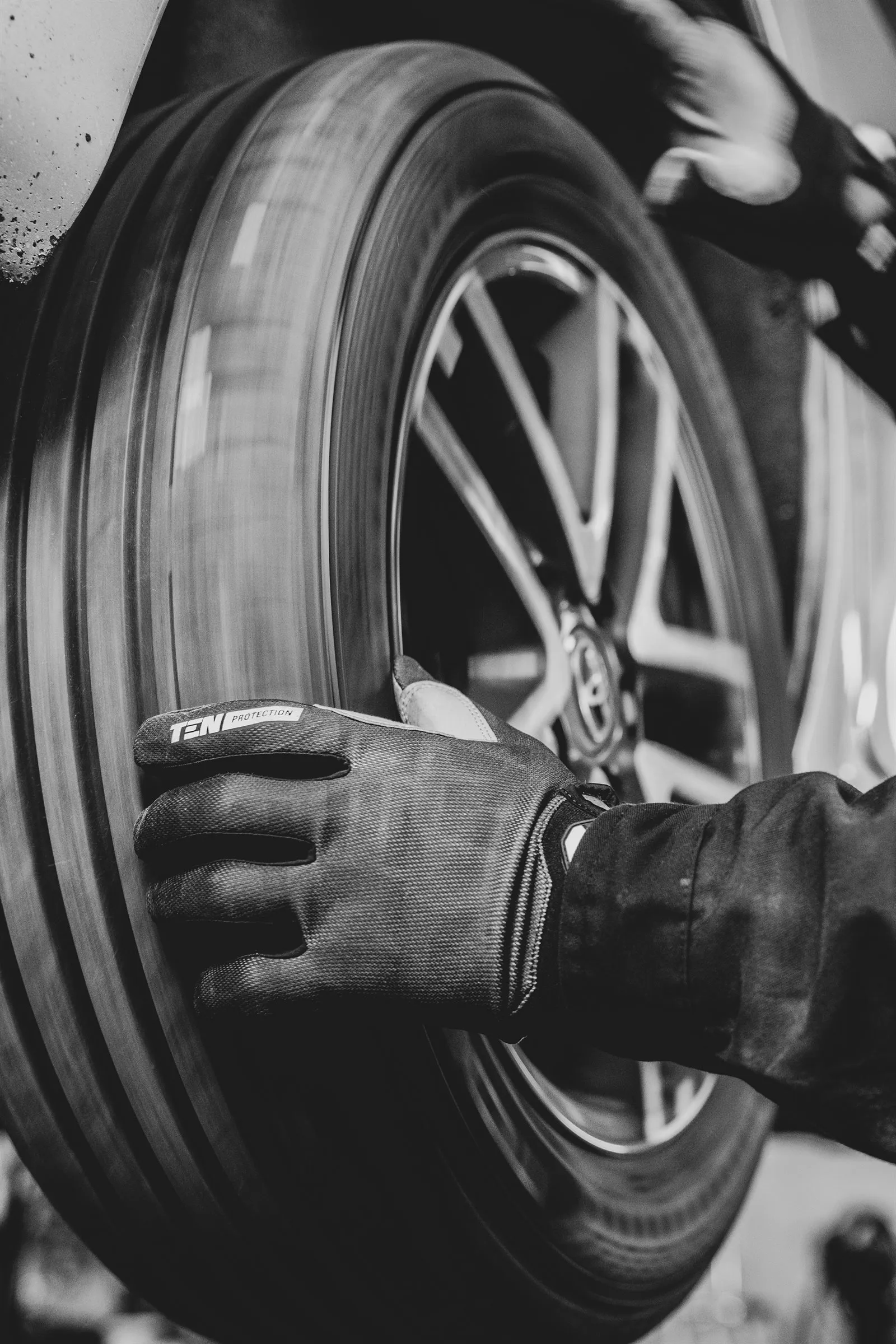 Technician holding a tire in the workshop