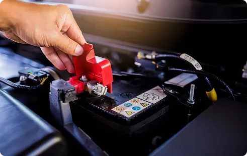 Jumper cable clamp attached to a car battery
