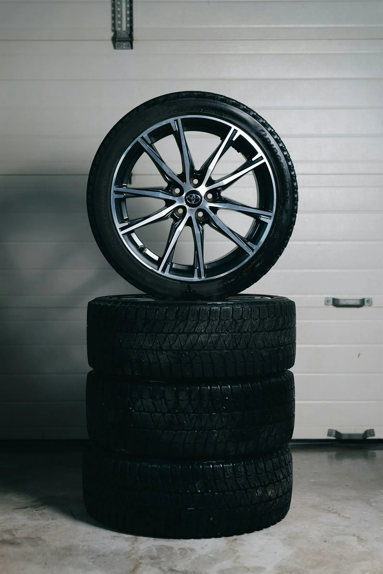 Stack of tires with an alloy wheel on top